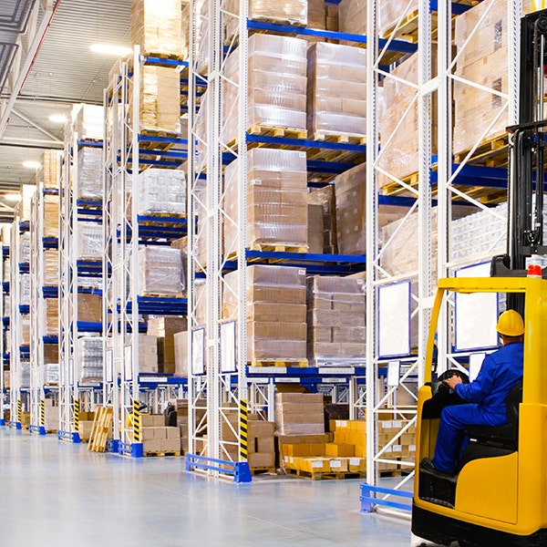 Shelves of packaged pallets and boxes in a storage space for inventory