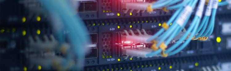 Close-up of fiber cables plugged into a cabling system
