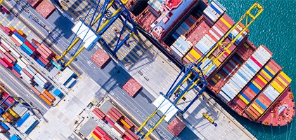 Cargo port filled with colorful shipping bins and lined paths