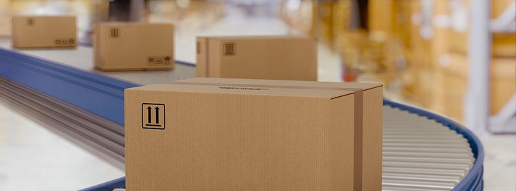 Multiple boxes going through a conveyor belt in an assembly line