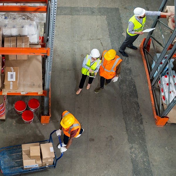 Looking above associates who are avidly working in the warehouse